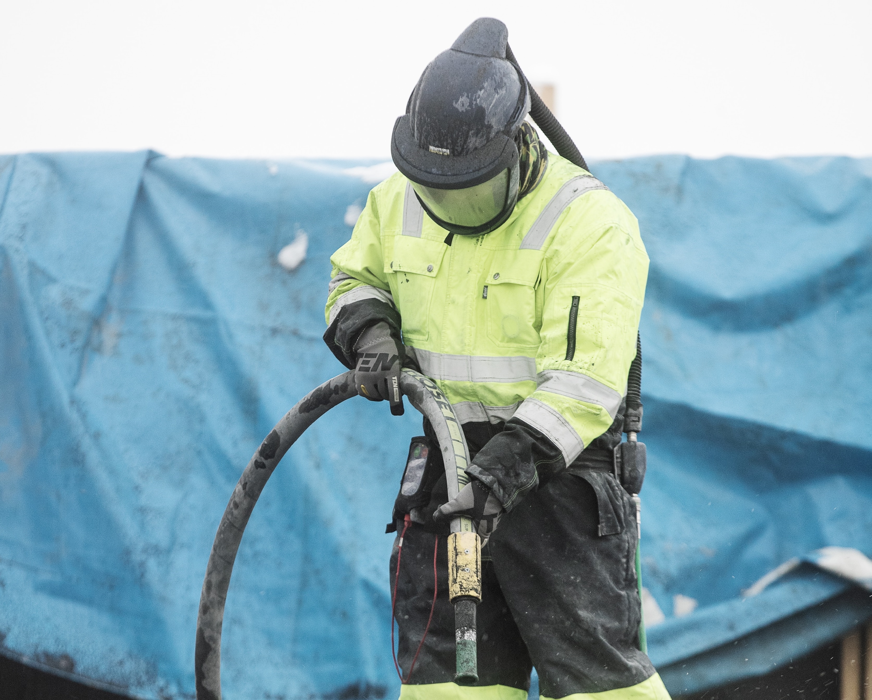 Worker in PPE Sandblasting